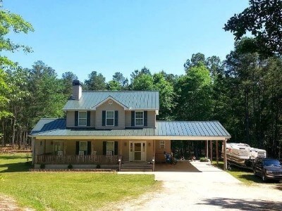 House with forest green snaplock roofing