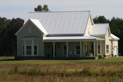Galvalume rib roof over a cream-colored house