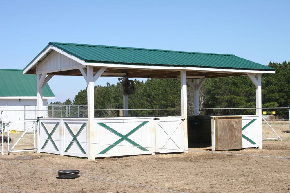 Animal enclosure with a forest green rib roof