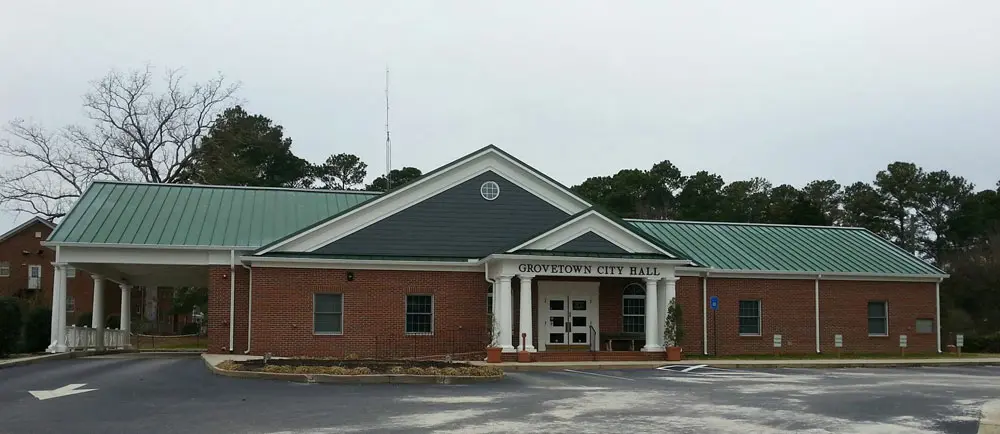 Forest green metal roofing over Grovetown City Hall